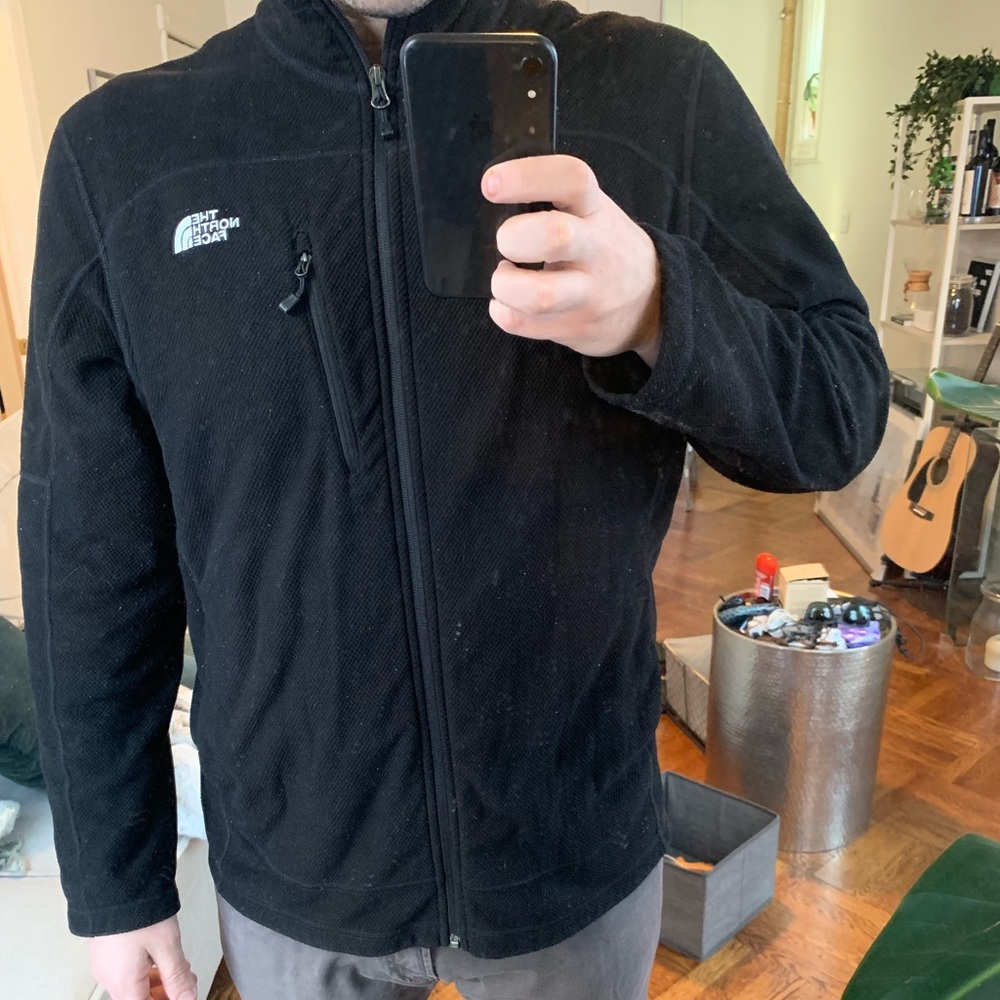 Black North Face zip up jacket.